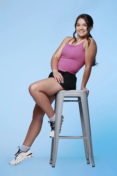Jaelyn Speck seated on studio stool